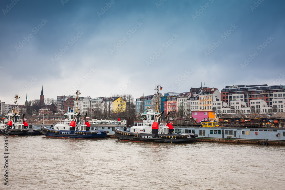 Tugboats docked at the Hamburg port on the banks of the Elbe river