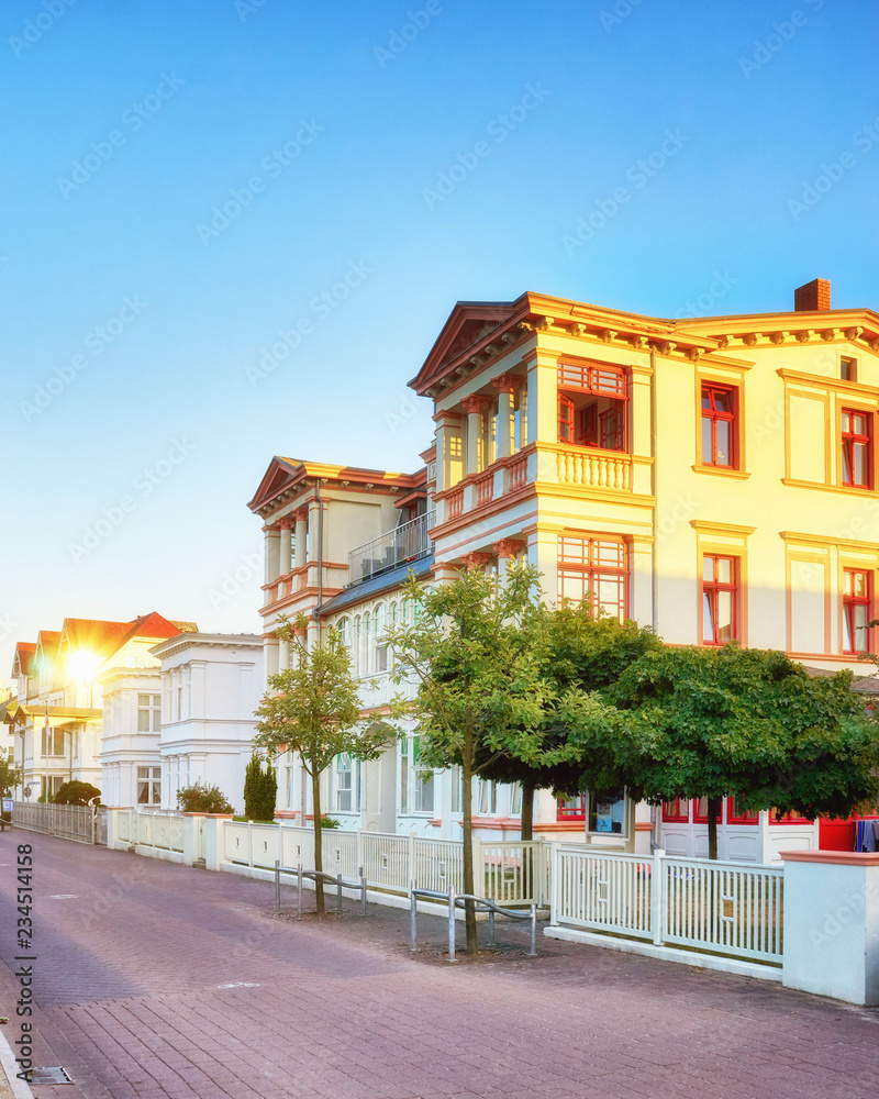 Street with Baltic architecture spotlighted by the sun in Ahlbeck. Germany