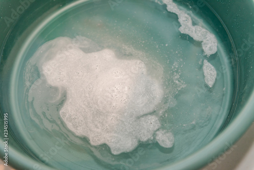 Soapy water in the pelvic area. Lather. Basin for washing clothes.
