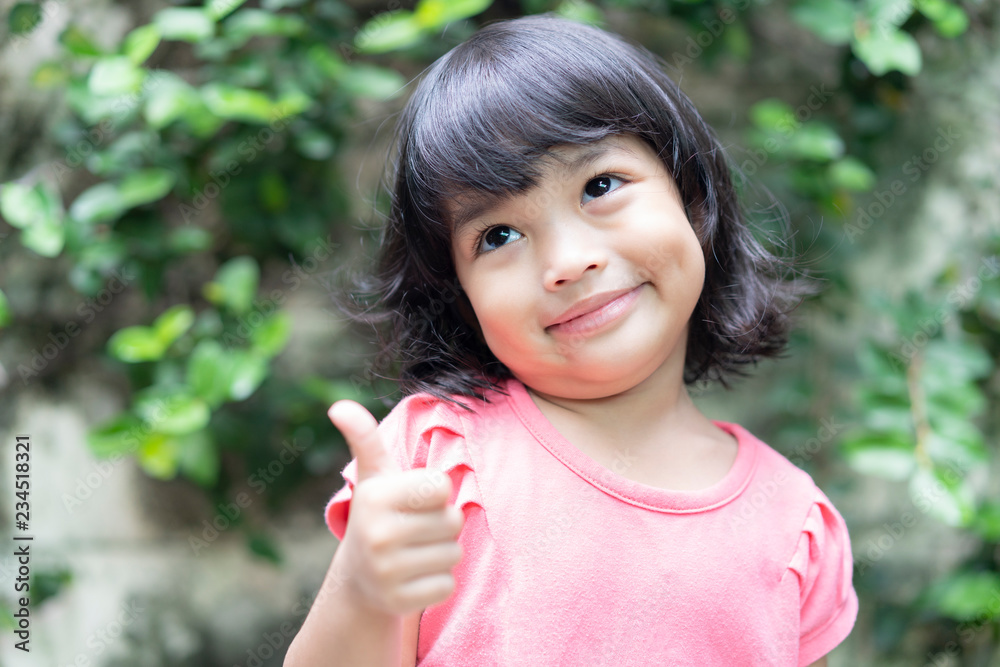 Asian little cute girl happy cheerful woman showing thumb up. Asian little cute girl happy cheerful woman showing thumb up.