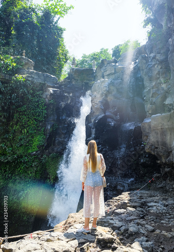 Fototapeta Naklejka Na Ścianę i Meble -  Girl on the background of a waterfall