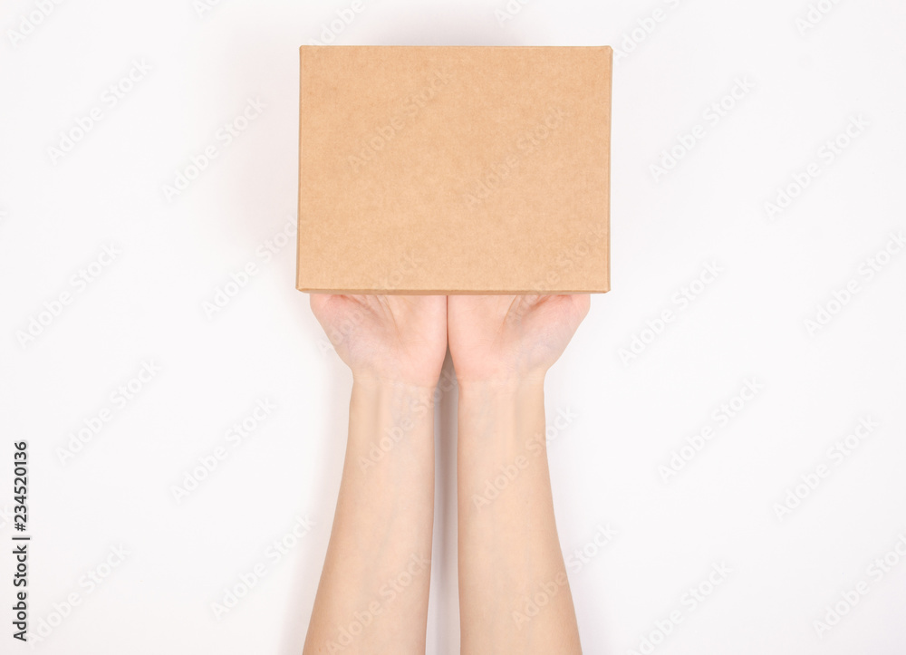 Fototapeta premium Box in hand. Isolation top view on white background.