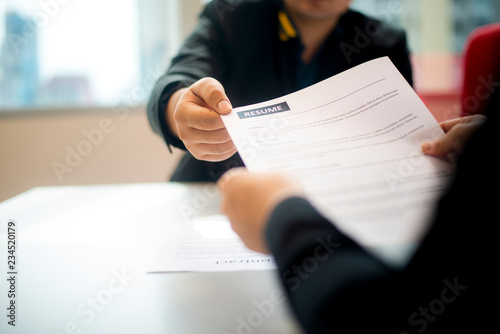 Recruitment,contract and business  employment concept. Hand giving the resume to the recruiter to review the profile of the applicant.
