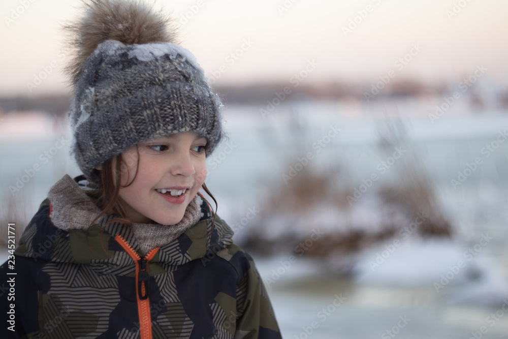 winter evening. girl playing on the background of the river winter evening. girl playing on the background of the river