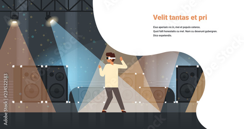 man dancer wear virtual reality glasses dancing on stage with light effects disco studio musical equipment multimedia speaker background flat horizontal copy space