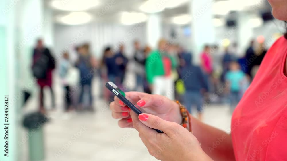 Tourist traveler woman, close-up of female hands texting messenger or typing sms on smart phone in terminal of airport. Travel technology concept. girl writing message in mobile phone smartphone 4 K