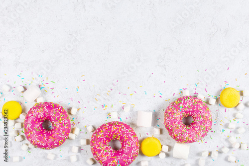 Light background with donuts, macarons and marshmallow