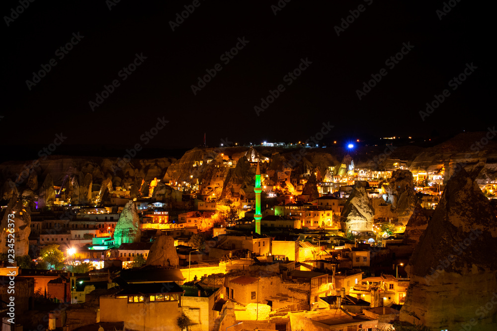 City at night illuminated by lights. Cappadocia, Goreme, Turkey. Aerial view