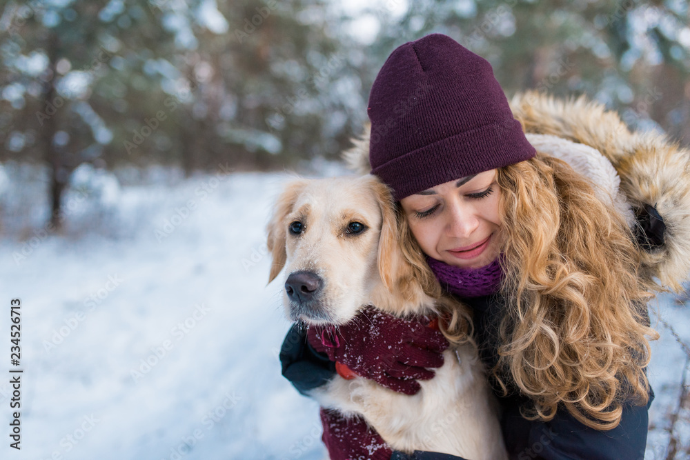 Young beautiful woman hugging her golden retriever dog Young beautiful woman hugging her golden retriever dog
