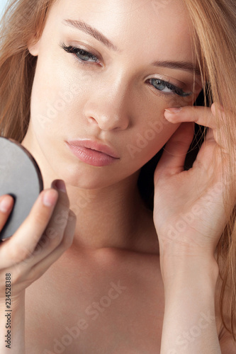 Young beautiful girl with clean perfect skin close-up