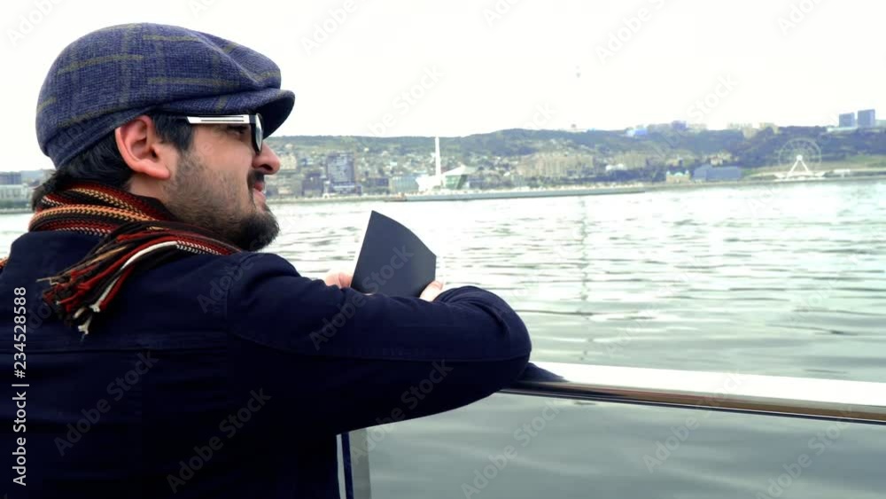Man going on sea tour in autumn. City panorama. 4K Man going on sea tour in autumn. City panorama. 4K
