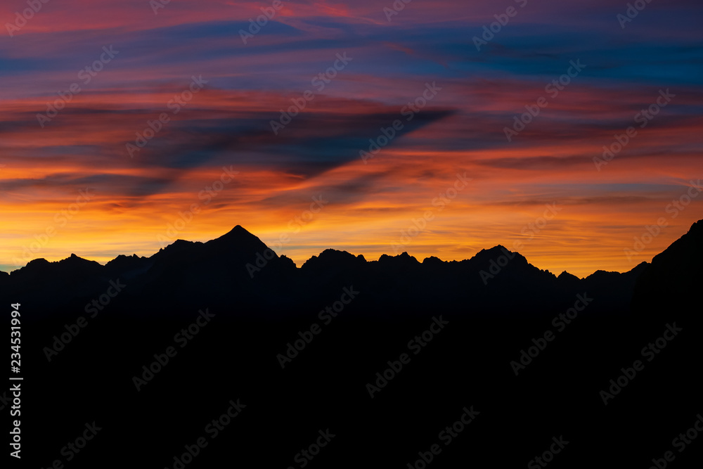 Dark Silhouette of Mountains and sunset. Mountain peaks Dolomites. Brenta, Italy