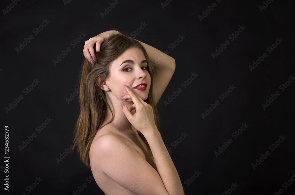 Portrait of brunette with long hair and makeup on dark background. Portrait of brunette with long hair and makeup on dark background.