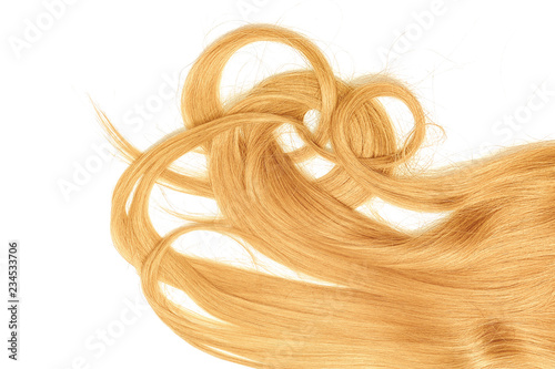 A strands of long, twisted, blond hair isolated on white background