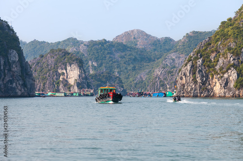 Ha Long Bay, Vietnam-December 20, 2013. Common life scene with fishing boats and commuting people at floating fishing village on December 20, 2013 in Ha Long Bay of northeast Vietnam.