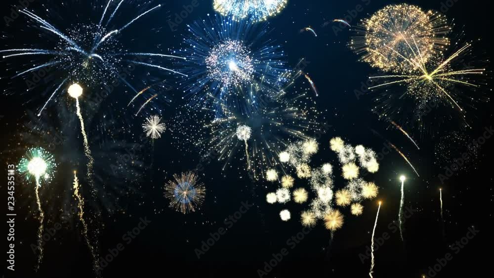 Brightly colorful fireworks for New Year and other events celebration on dark blue background. 4k