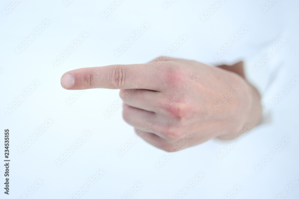 man's hand breaking through the paper wall and pointing at you