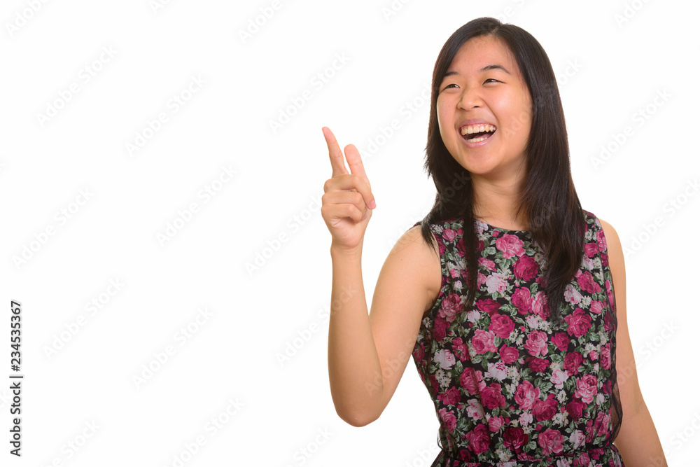 Young happy Asian woman laughing while pointing finger Young happy Asian woman laughing while pointing finger