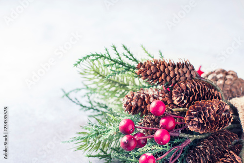 Fototapeta Naklejka Na Ścianę i Meble -  New Year and Christmas background. Christmas frame with decoration, sprig of pine, cones and berries. Place for text.