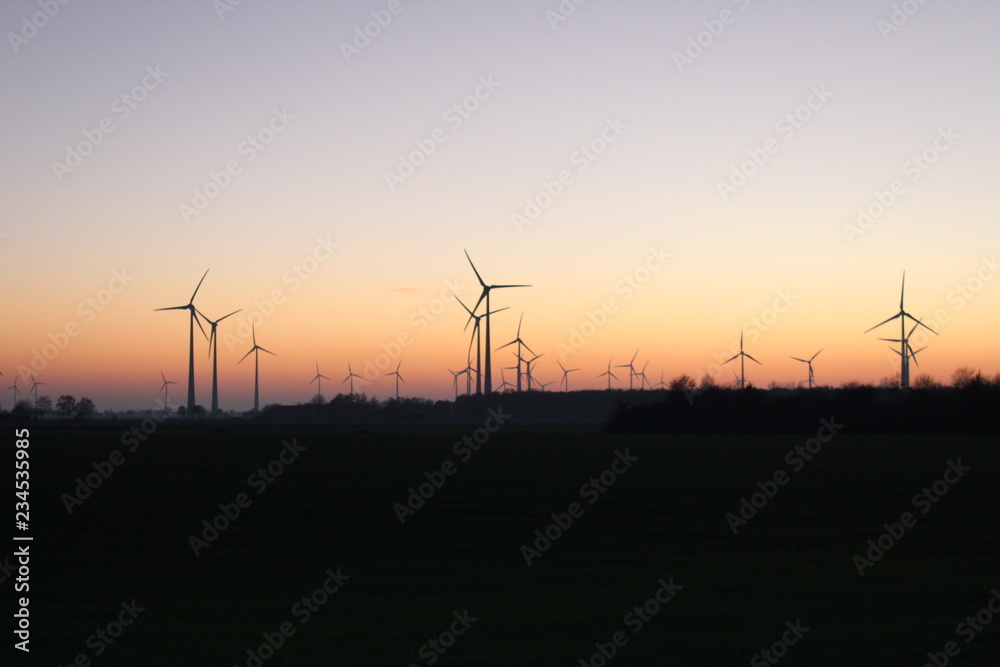 Wind farm in front of autumnal red sunset