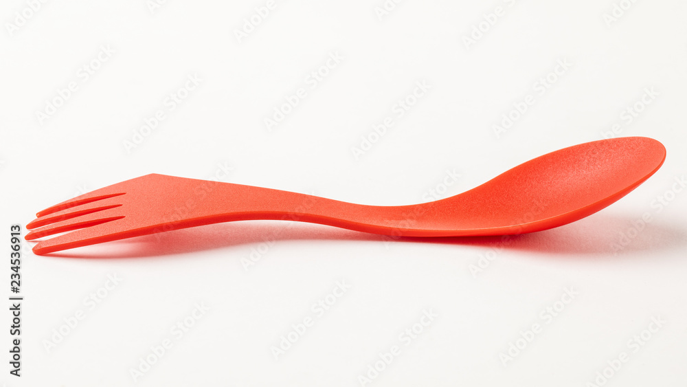 Red, light, plastic travel spoon fork on white background. Red, light, plastic travel spoon fork on white background.