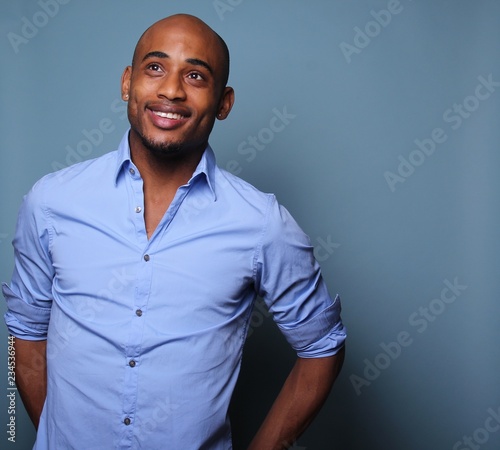 Black man in front of a colored background
