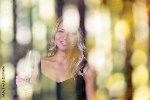Happy smiling woman with a glass of champagne