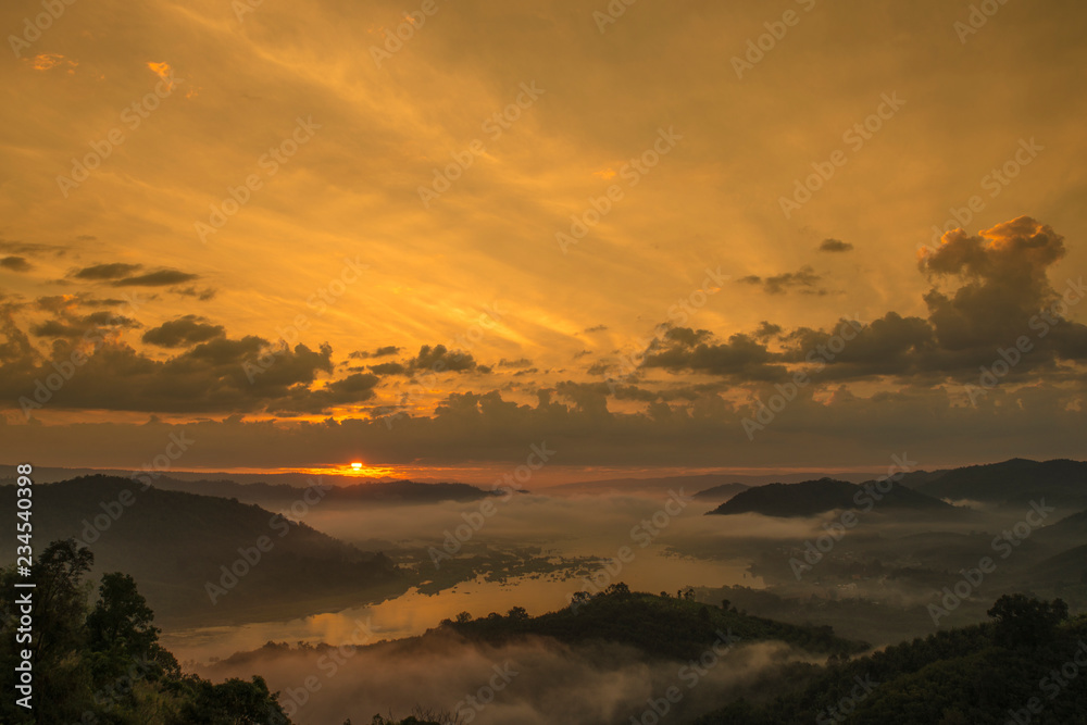 Sun rise and fog over Mekong river at the early morning , shooting from the top of the mountain called  Phu-Huay-Esan hill located in Amphoe Sangkom, Nongkhai province, Thailand.