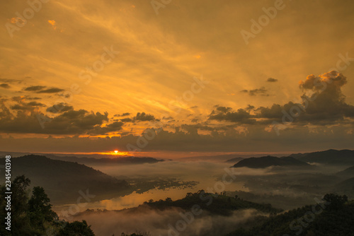 Sun rise and fog over Mekong river at the early morning , shooting from the top of the mountain called  Phu-Huay-Esan hill located in Amphoe Sangkom, Nongkhai province, Thailand.