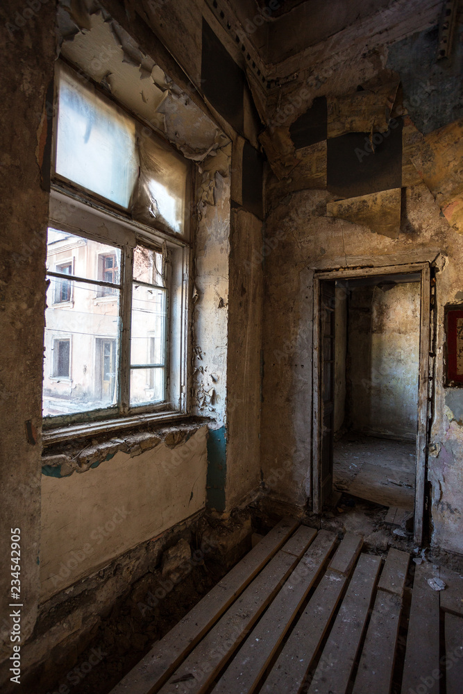 Broken glass in the windows of an old abandoned mystical house. A horror picture of broken window glass. Gloomy interior, depressive background for the design of tragedy, horror, Halloween