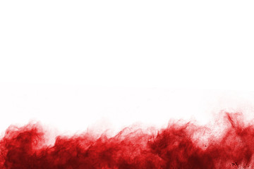 Freeze motion of red powder exploding, isolated on white background. Abstract design of red dust cloud. Particles explosion screen saver, wallpaper