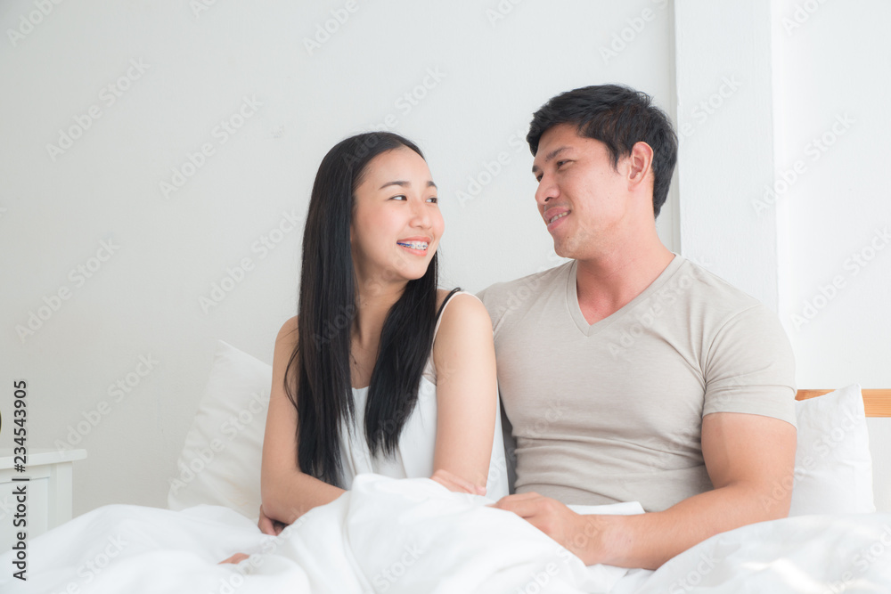 Young lovely couple on the bed together with smiling and happiness. boyfriend,girlfriend, love and valentine concept Young lovely couple on the bed together with smiling and happiness. boyfriend,girlfriend, love and valentine concept