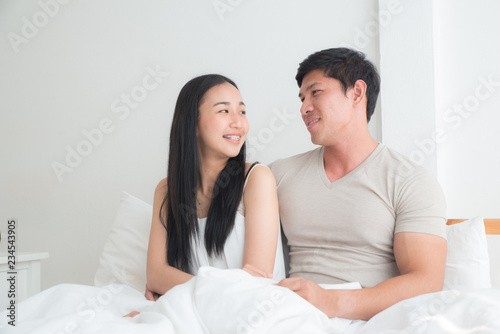 Young lovely couple on the bed together with smiling and happiness. boyfriend,girlfriend, love and valentine concept © Asada