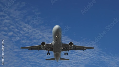 Slow motion. Commercial jet coming into land with landing lights. Airbus A320-211 landing at YYZ in Toronto. No visible logos. 