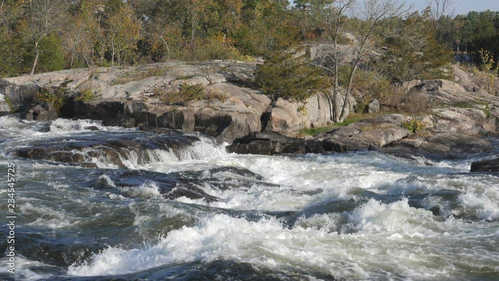 Slow motion view of strong white water and river rapids with rocks. Autumn in Burleigh Falls, Ontario, Canada. Slow motion view of strong white water and river rapids with rocks. Autumn in Burleigh Falls, Ontario, Canada.