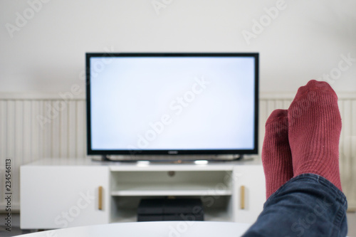 Feet up in front of TV with a blank screen