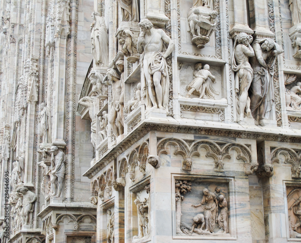 ITALY, MILAN - November 12, 2018: Beautiful architectural details, bas-relief and sculptures of Milan Cathedral (Duomo di Milano)