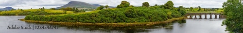 Panorama with river, stone bridge and mountains in background, Great Western Greenway trail
