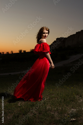 a gorgeous woman against the sunset horizon