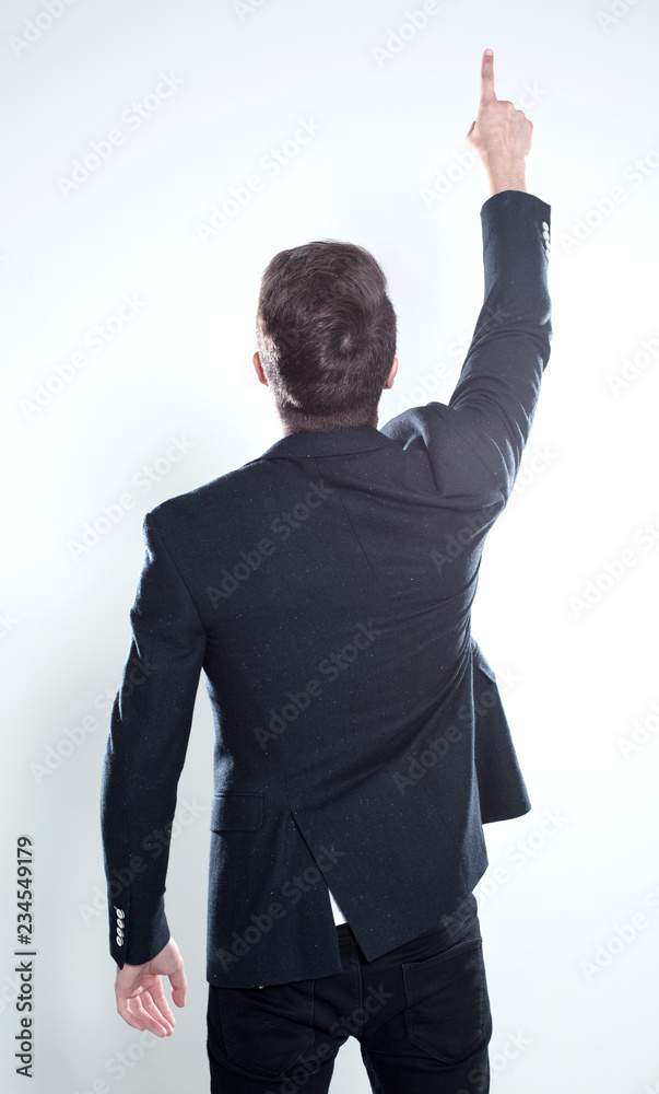 Attractive young man in suit pointing up with his finger isolate Attractive young man in suit pointing up with his finger isolate