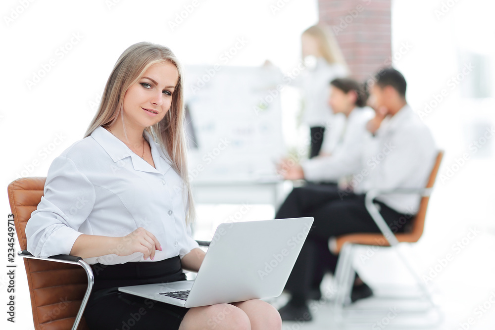 Executive business woman with a laptop on blurred background Executive business woman with a laptop on blurred background