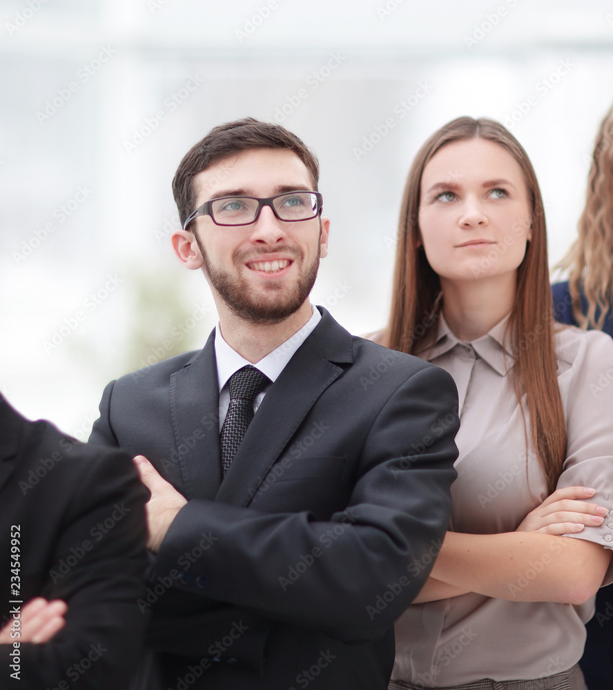 close up.Smiling and confident business team stands in the office close up.Smiling and confident business team stands in the office