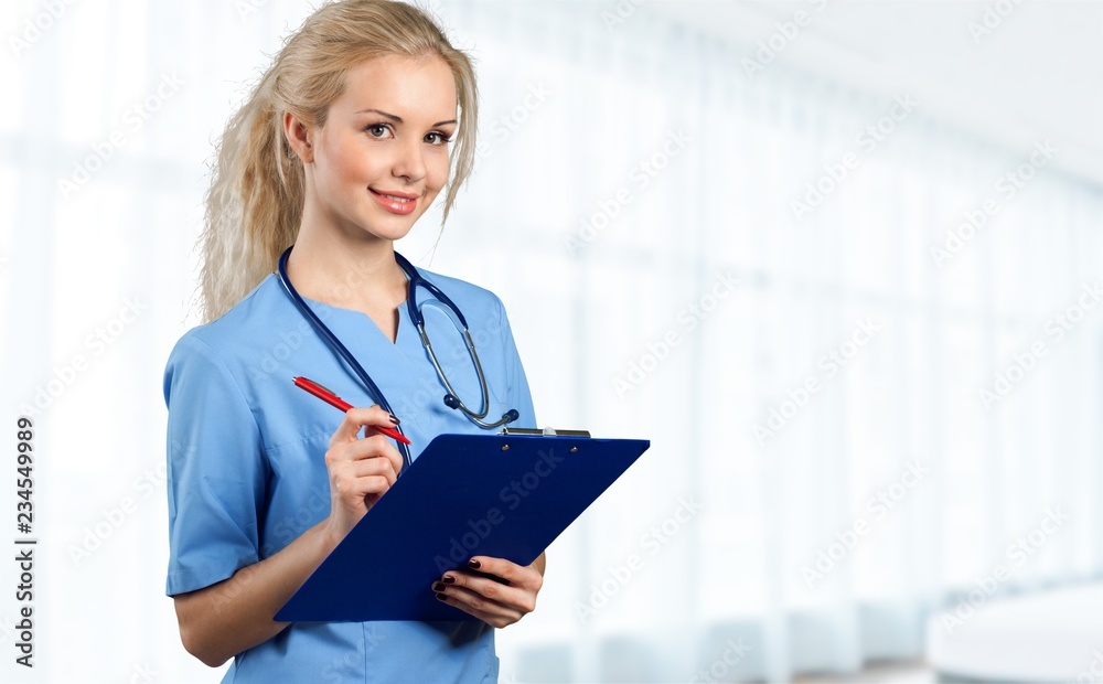 Nurse student with books and stethoscope in library Nurse student with books and stethoscope in library