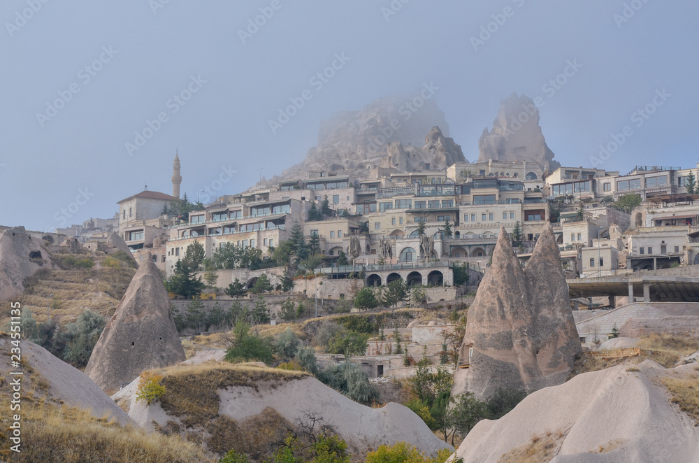 Uchisar castle rock hiding in the clouds Cappadocia, Turkey