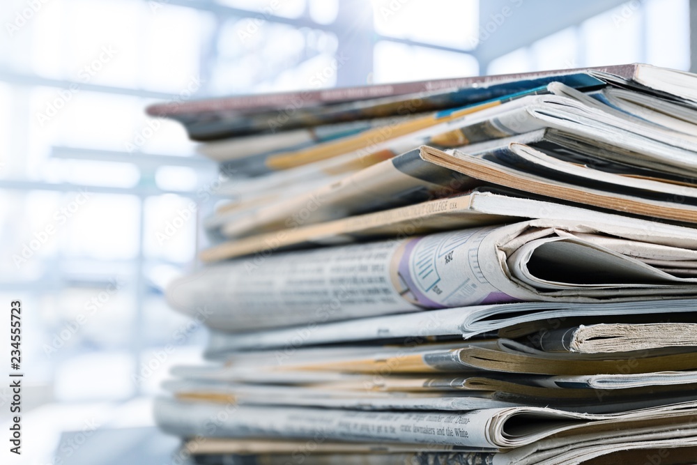 Pile of printed newspapers on white background Pile of printed newspapers on white background