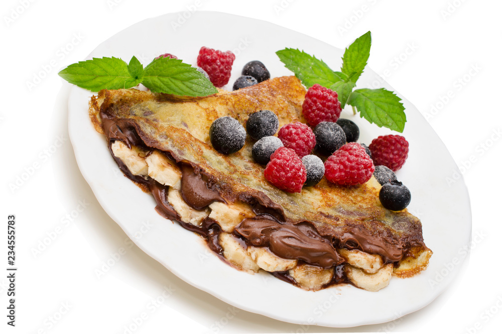 Homemade crepes served with chocolate cream, fresh blueberries and raspberries, powdered sugar on a white background Homemade crepes served with chocolate cream, fresh blueberries and raspberries, powdered sugar on a white background