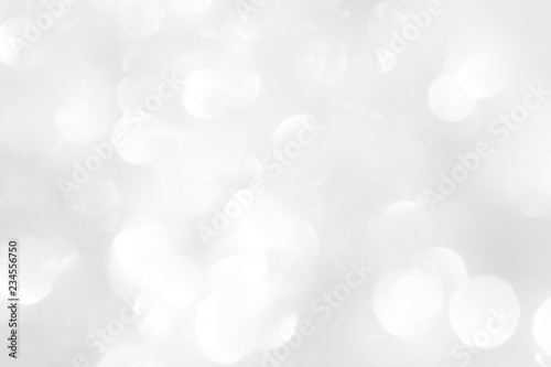 A brilliant white background with circles and ovals. Template for a holiday card with bright and sparkling lights.