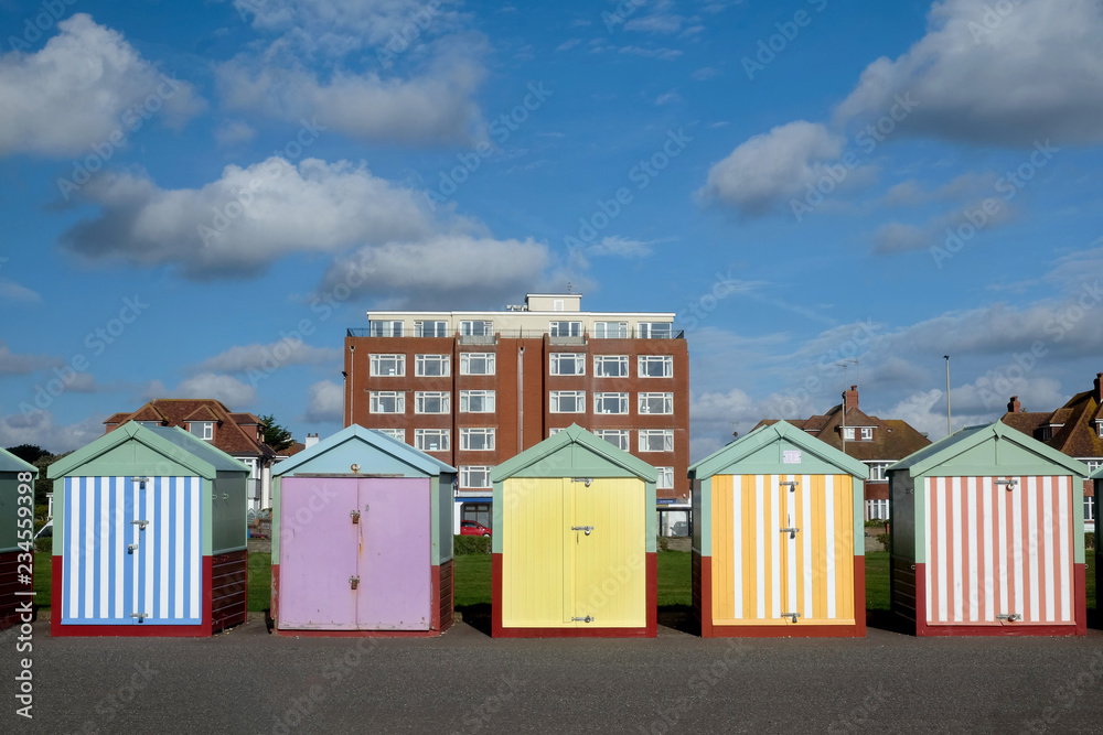 a line of five beach huts on Brighton promenade 5 beach huts are