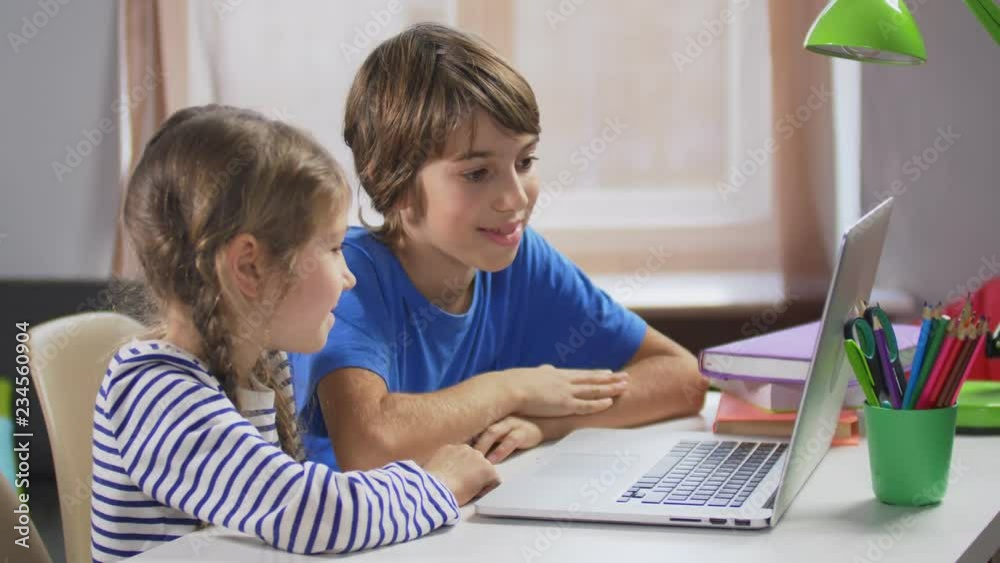 Boy and girl using parents credit card for app Boy and girl using parents credit card for app