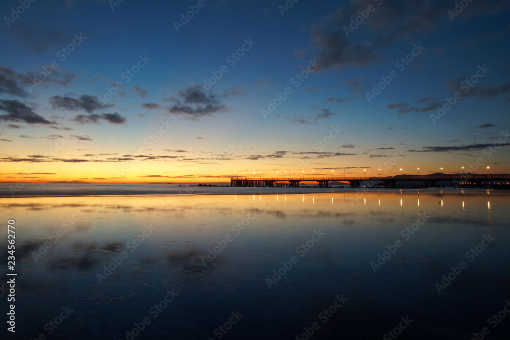Naklejka premium reflections on the beach with a bridge
